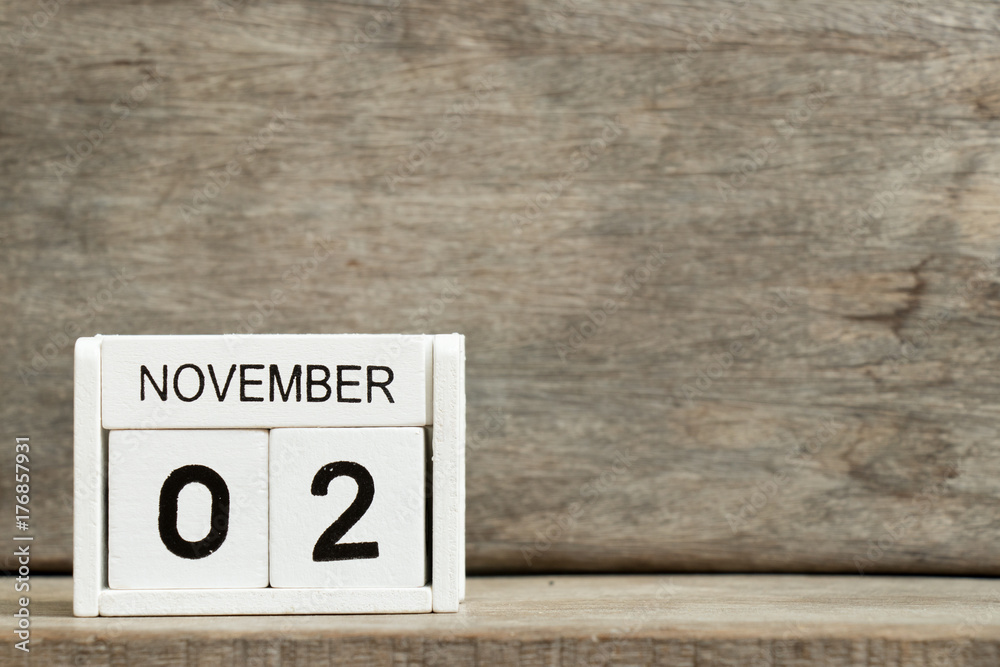 White block calendar present date 2 and month November on wood background White block calendar present date 2 and month November on wood background