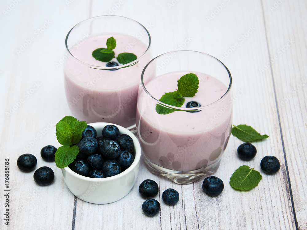 Glasses with blueberry yogurt on a table Glasses with blueberry yogurt on a table