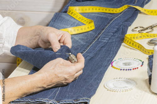 Una costurera hivanando el bajo de los pantalones
