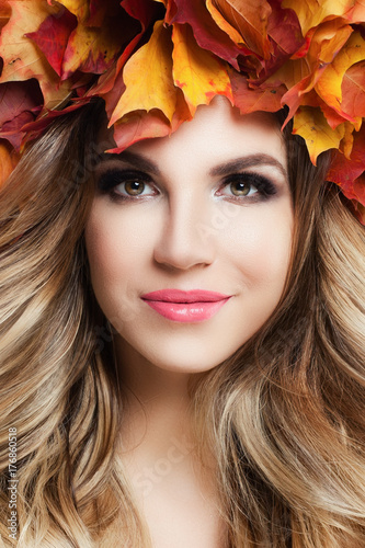 Young Beautiful Woman with Perfect Curly Blonde Hairstyle  Makeup and Fall Leaves Wreath  Cute Female Face Closeup