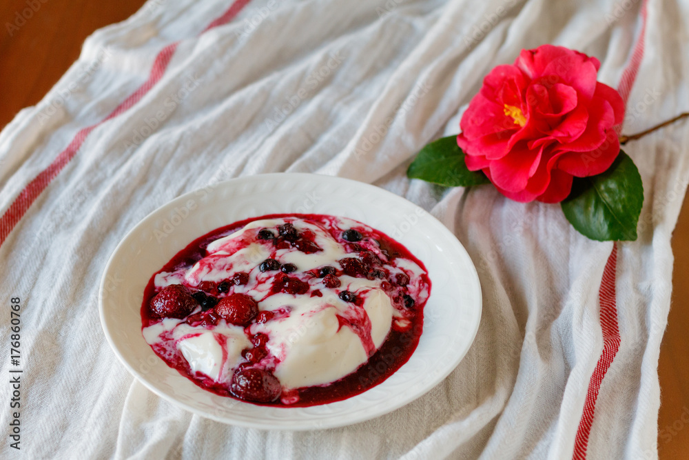 dessert named panacota. With chocolate and jam, on a wooden table dessert named panacota. With chocolate and jam, on a wooden table