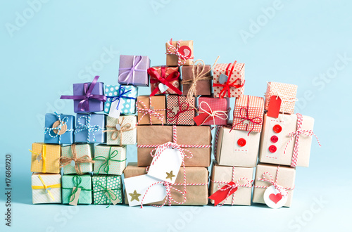 Collection of Christmas present boxes on a light blue background photo