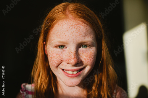 Portrait of redhead girl with freckles photo