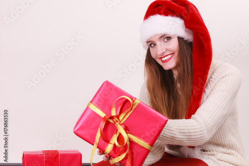 Woman holding gift box. Christmas time