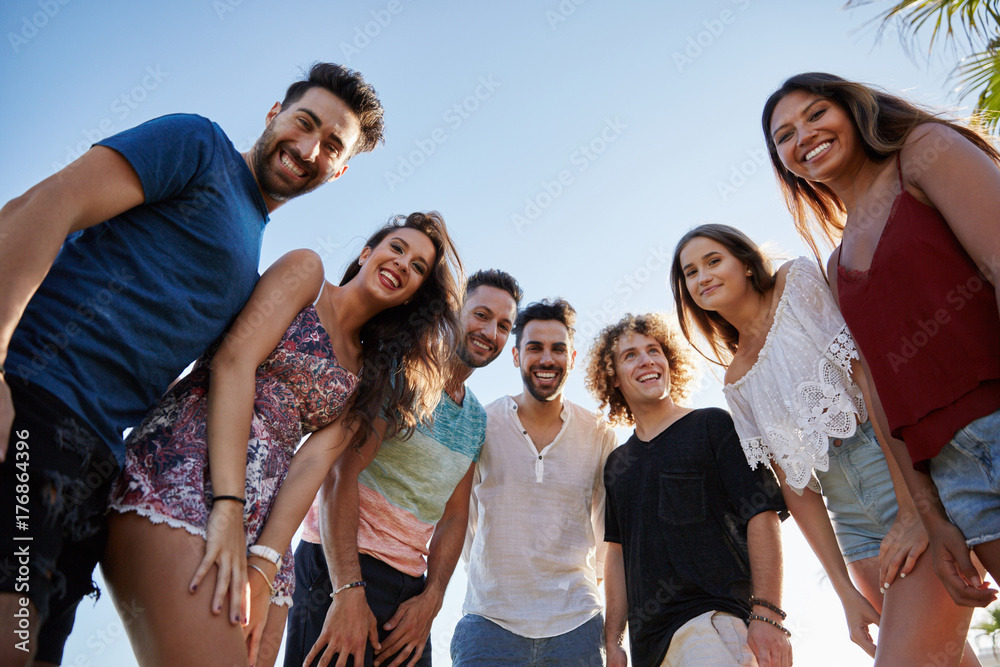 Group of friends standing together outside smiling Group of friends standing together outside smiling