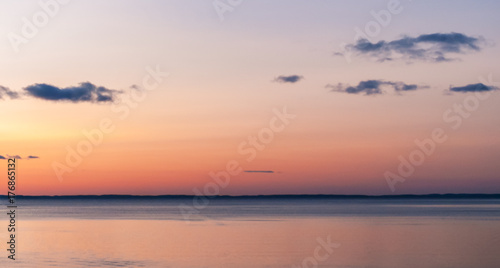 Sunset on the sea. pink sky with clouds