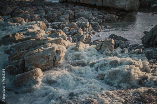 Rocks with Foam over it from rough sea
