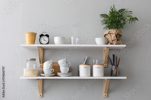 Vászonkép Utensils and mugs on shelf