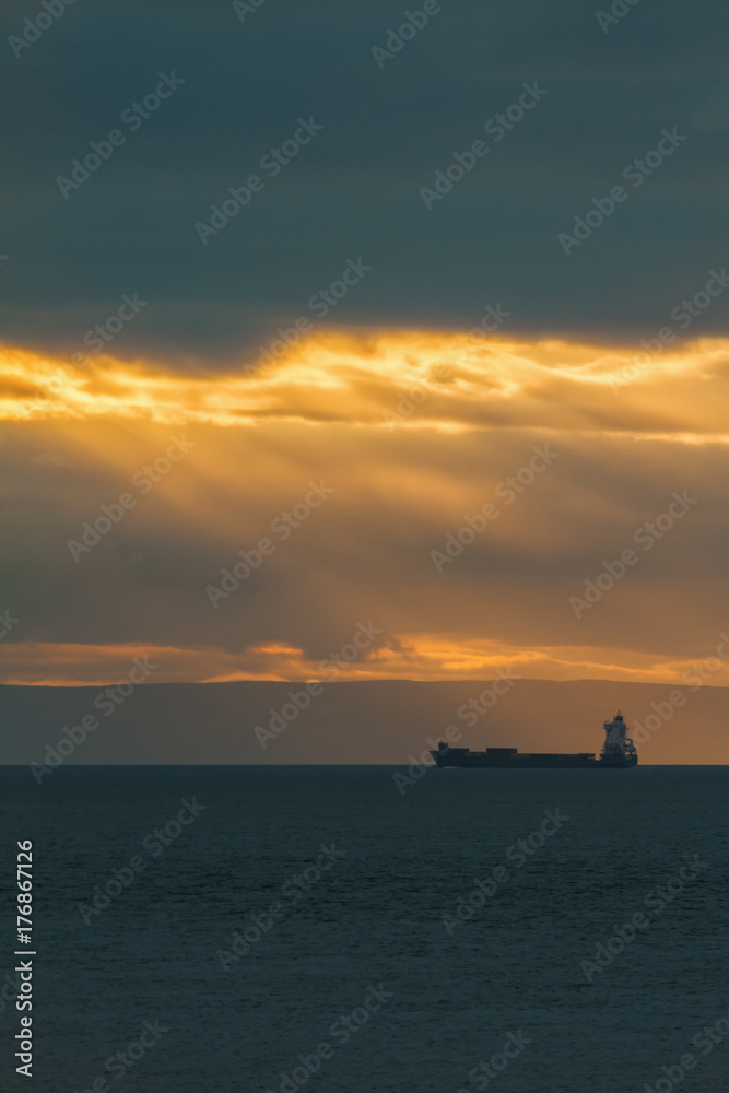 Container Cargo ship in the ocean at sunset sky, silhouette Container Cargo ship in the ocean at sunset sky, silhouette