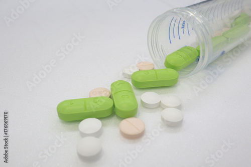 Pills above white background
