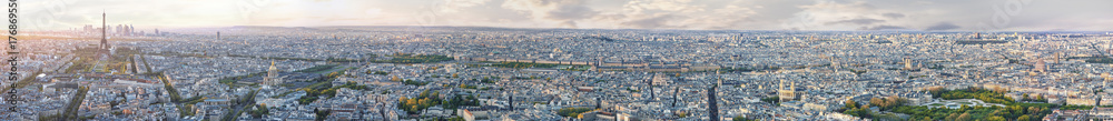 Panoramic aerilal view of whole Paris from Eiffel tower to Notre Dame cathedral at sunset. Copy space in sky.