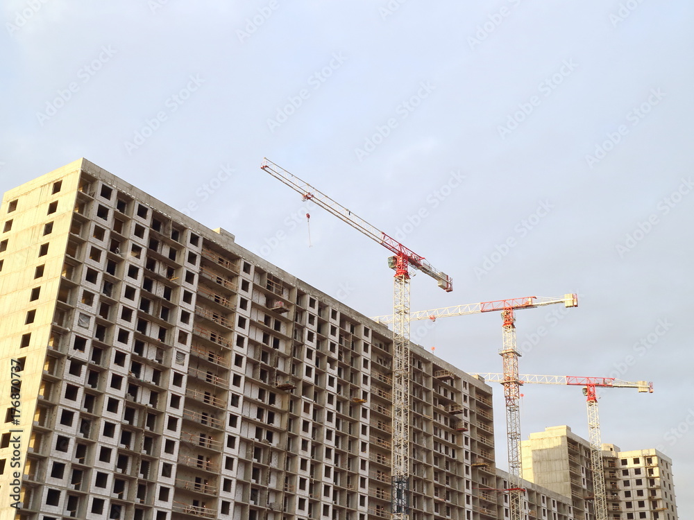 Building construction, tower cranes, low angle Building construction, tower cranes, low angle