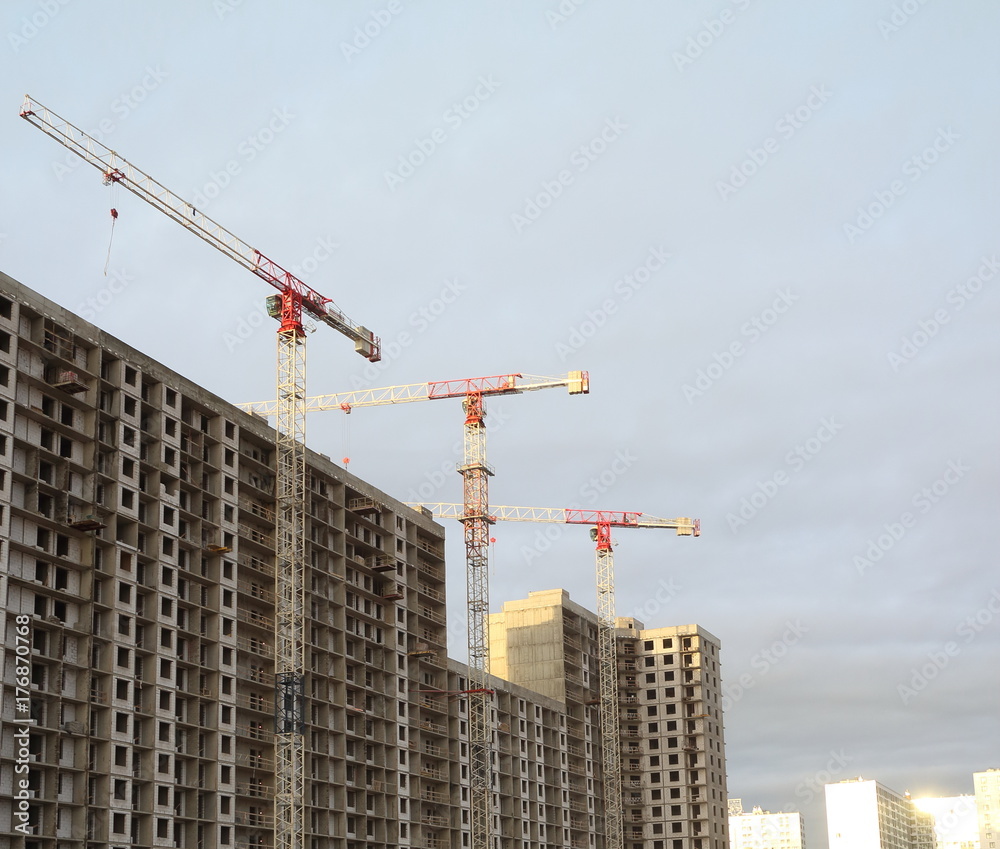 Building construction, tower cranes, low angle Building construction, tower cranes, low angle