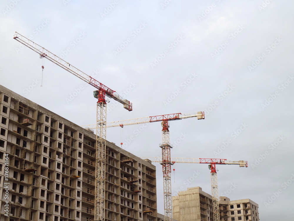 Building construction, tower cranes, low angle Building construction, tower cranes, low angle
