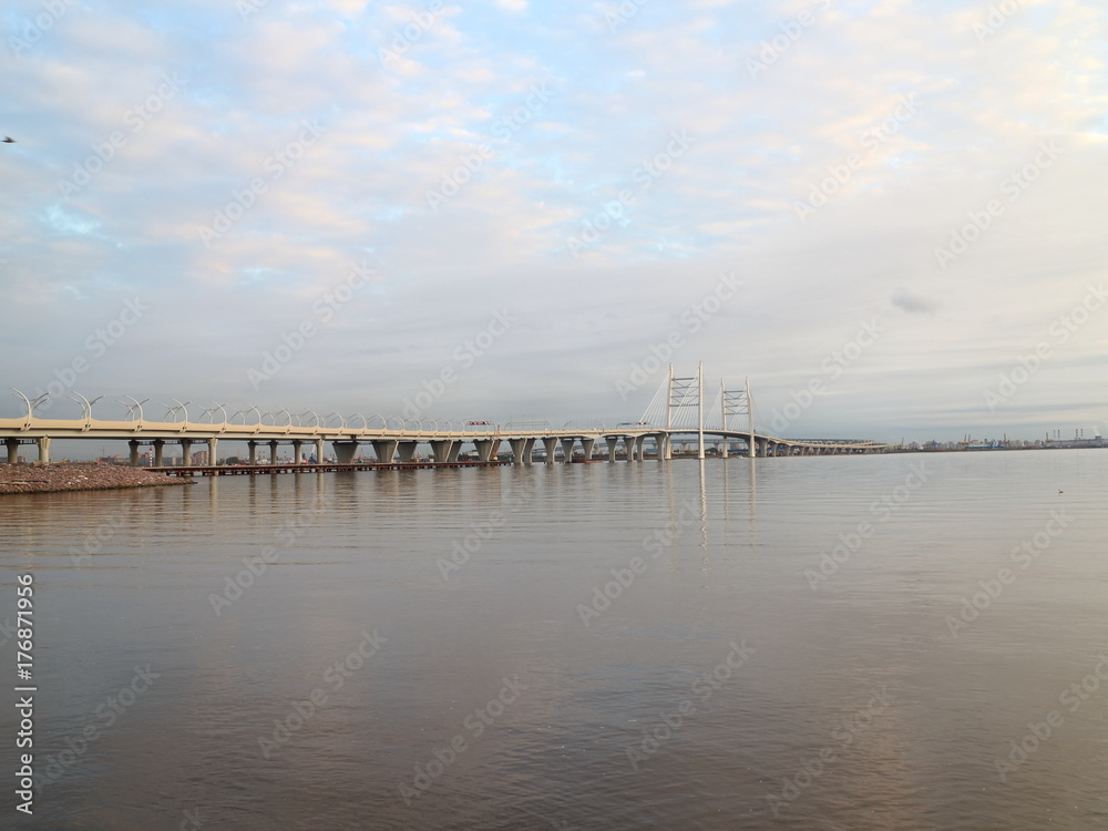 Cable-stayed bridge over the big river in the evening