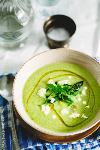 Courgette soup with asparagus and goats cheese garnish.