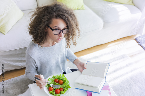 Curly hair teen girl readin...