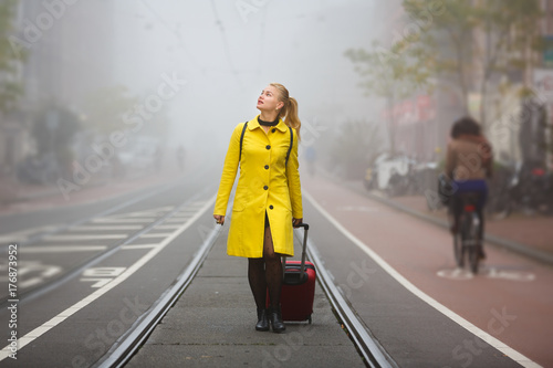 Traveler in misty Amsterdam