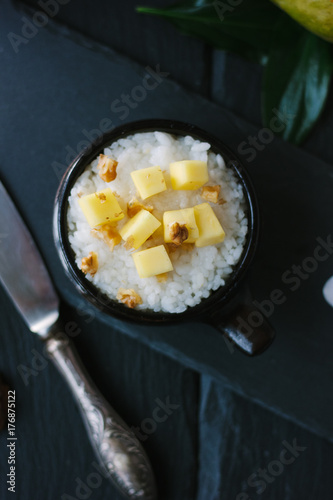 Top view of mango and rice dessert over black background.