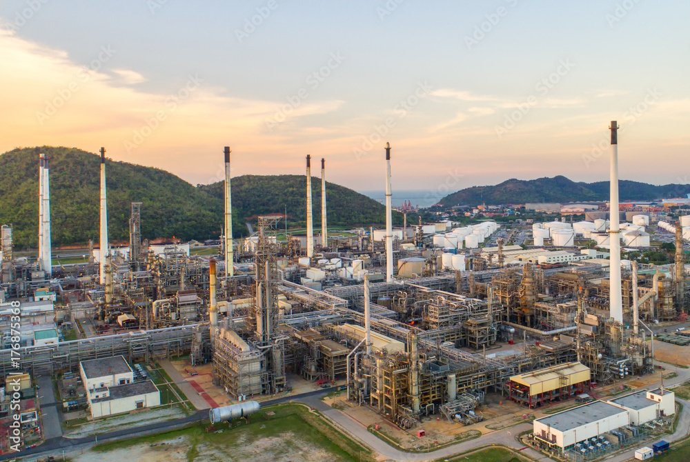 Obraz premium Aerial view Oil refinery.Industrial view at oil refinery plant form industry zone with sunrise and cloudy sky.Oil refinery and Petrochemical plant at dusk,Thailand. Oil refinery background sunset.