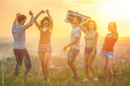 The five people dancing with a boom box on the mountain
