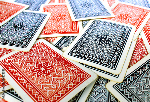 Texture of red and blue playing cards back spread on a table
