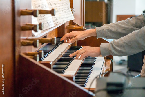 Close up view of a organist playing a pipe organ photo