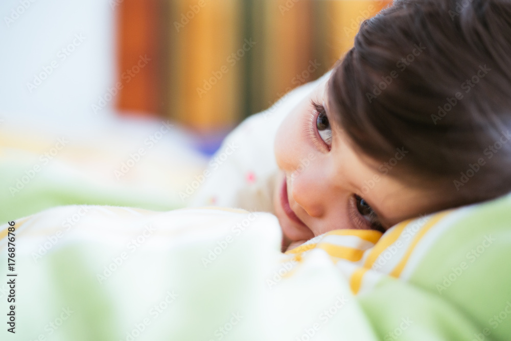 Baby lying down on a bed resting Baby lying down on a bed resting