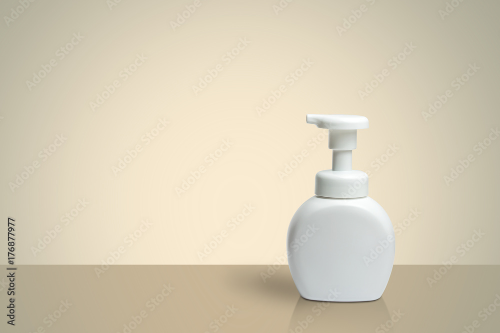 Pure white plastic pump bottle with shadow on light brown perspective background Pure white plastic pump bottle with shadow on light brown perspective background