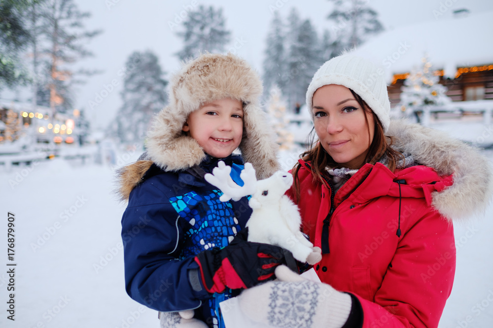 Happy mother with her son in a snow