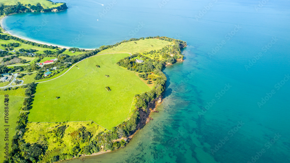 Aerial view on a farmland on the shore of sunny harbour. Whangaparoa peninsula, Auckland, New Zealand