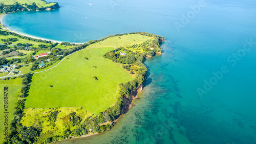 Aerial view on a farmland on the shore of sunny harbour. Whangaparoa peninsula, Auckland, New Zealand