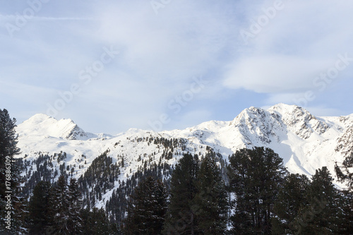 Mountain panorama with snow, trees and blue sky in winter in Stubai Alps, Austria © johannes86