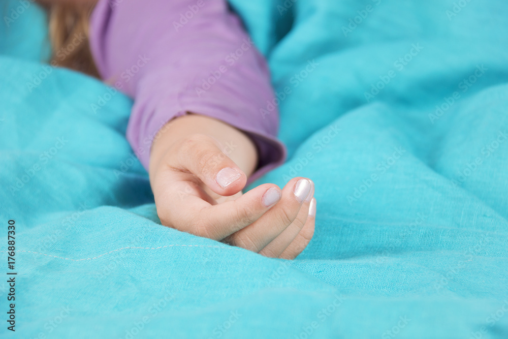 The girl is sleeping on the bed and the hand lies quietly while sleeping on the bed. The girl is sleeping on the bed and the hand lies quietly while sleeping on the bed.