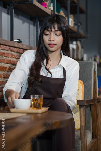 Barista prepares cappuccino in his coffee shop.,Asian woman working in coffee shop cafe barista concept