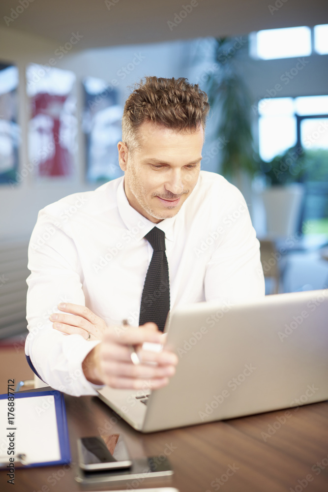 Businessman working on new project on laptop at office Businessman working on new project on laptop at office