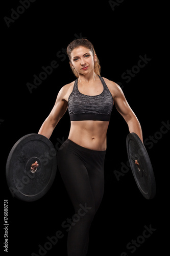 Sporty beautiful woman doing workout exercising at black background to stay fit. Fitness workout motivation.