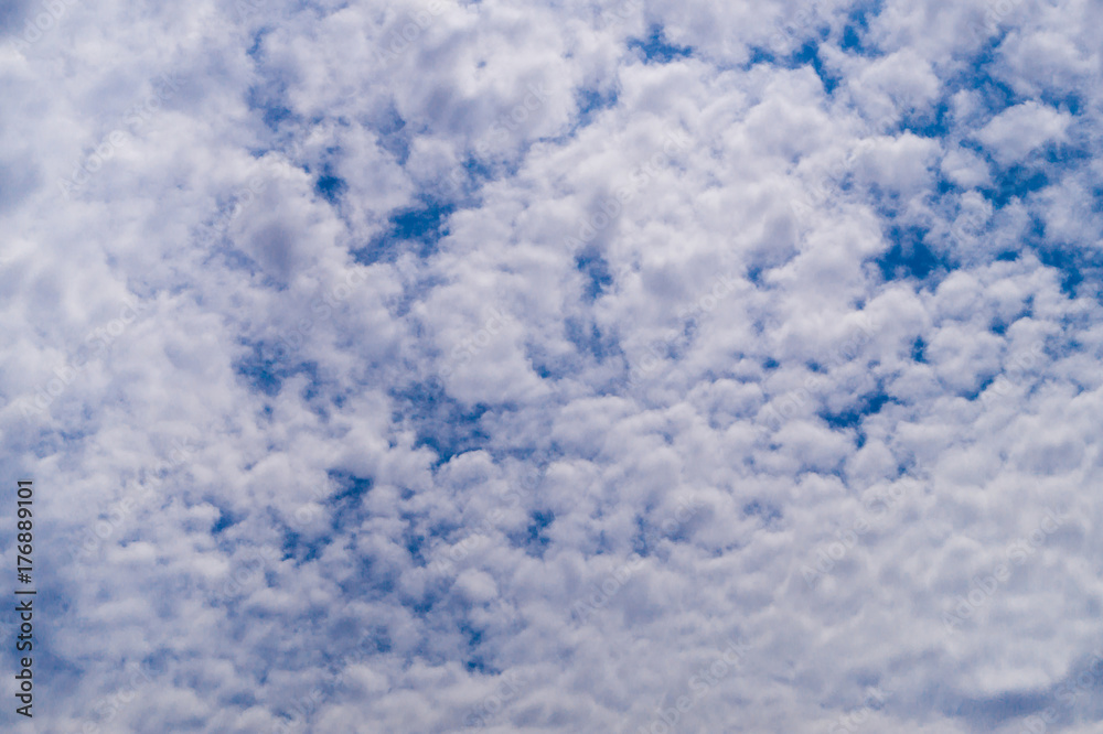 White fkuffy small clouds on the light-blue sky White fkuffy small clouds on the light-blue sky