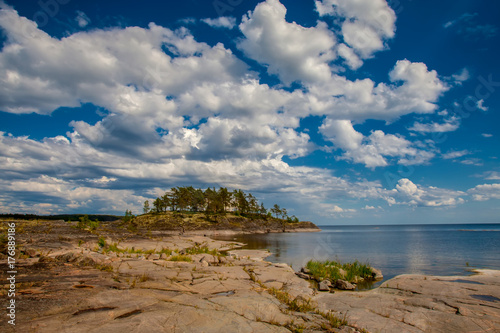 Island with stony shore. Island under the clouds. Karelia. Russia. Ladoga lake.