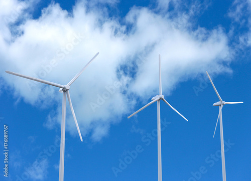 low angle view of white wind turbines engine with beautiful cloud and blue sky