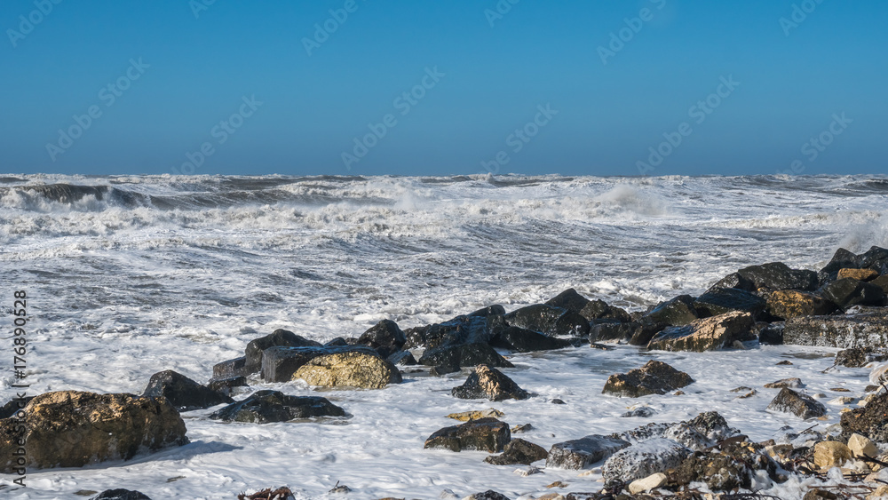 Stormy sea huge waves breaking near the coast
