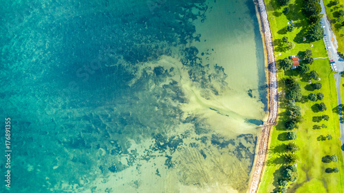 Aerial view on a farmland on the shore of sunny harbour. Whangaparoa peninsula, Auckland, New Zealand