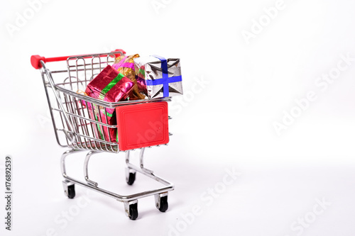 Shopping cart on white background with gift boxes © suman