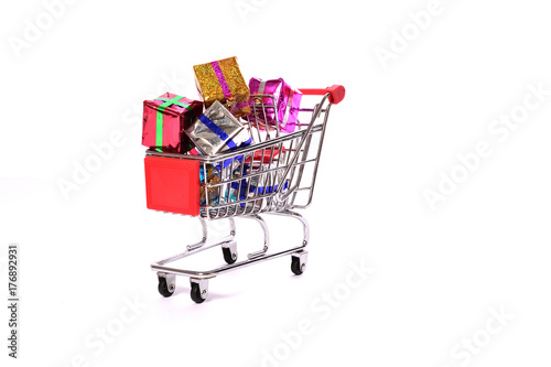 Shopping cart on white background with gift boxes