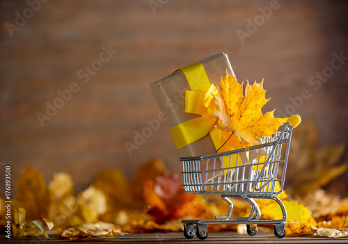 Vintage cart with gift box and maple tree leaves