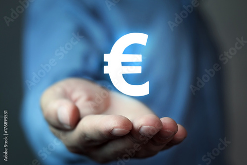 Businessman holding euro sign.