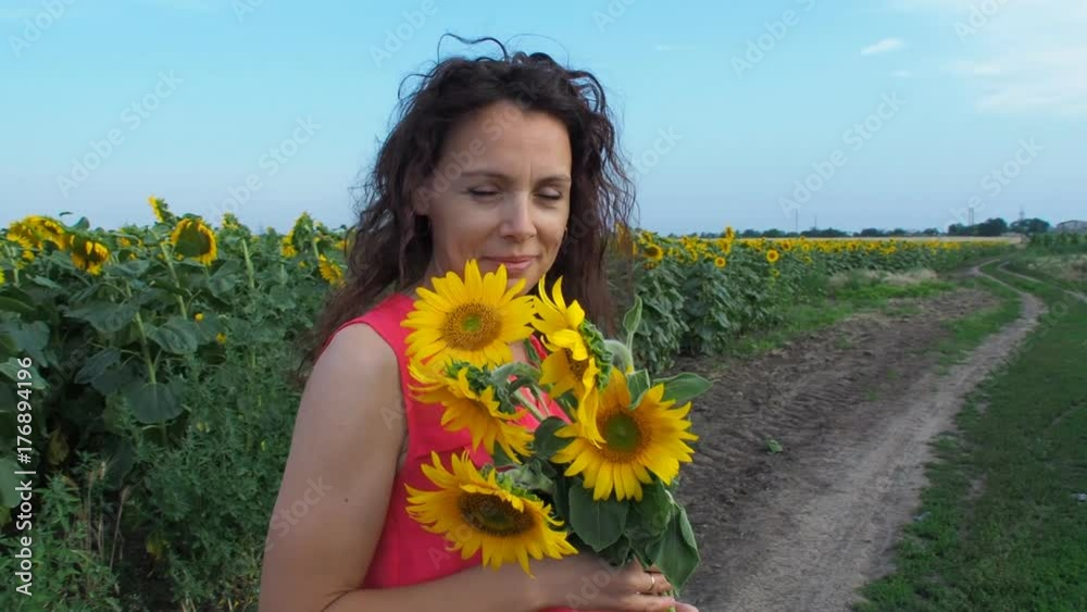 Woman with a bouquet of sunflowers in nature. Woman with a bouquet of sunflowers in nature.