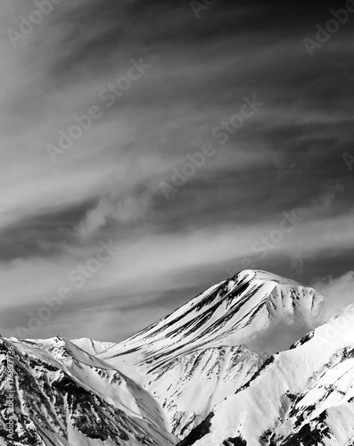Bild auf Leinwand Black and white winter snowy mountains in sun windy day