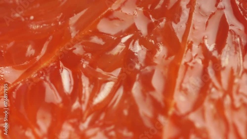 ripe grapefruit. Red color citrus fruit, rotates around the axis. Macro, studio light, advertising semk. photo