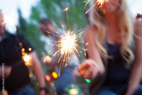 Cinco: Woman Holding Sparkler During Party photo